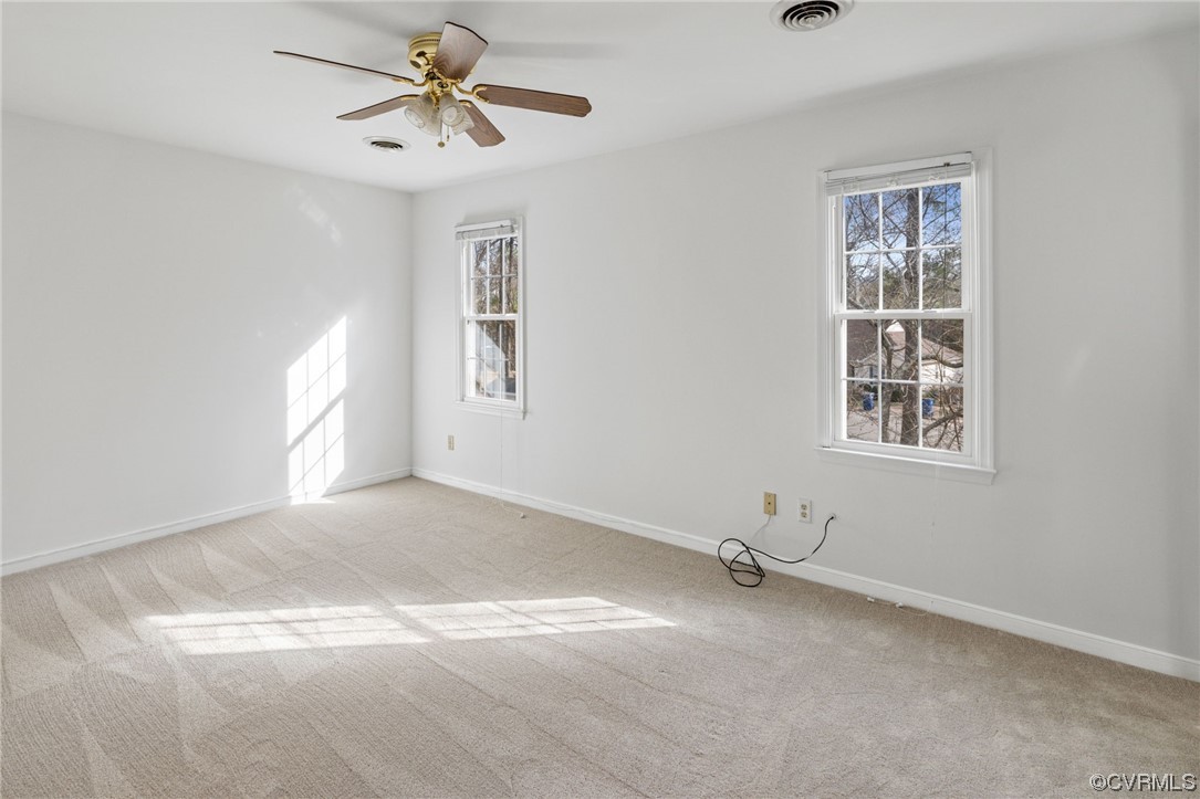 13605 Danwoods Road Midlothian, VA 23113 - Photo 11 of 20 a view of a livingroom with a window and a ceiling fan