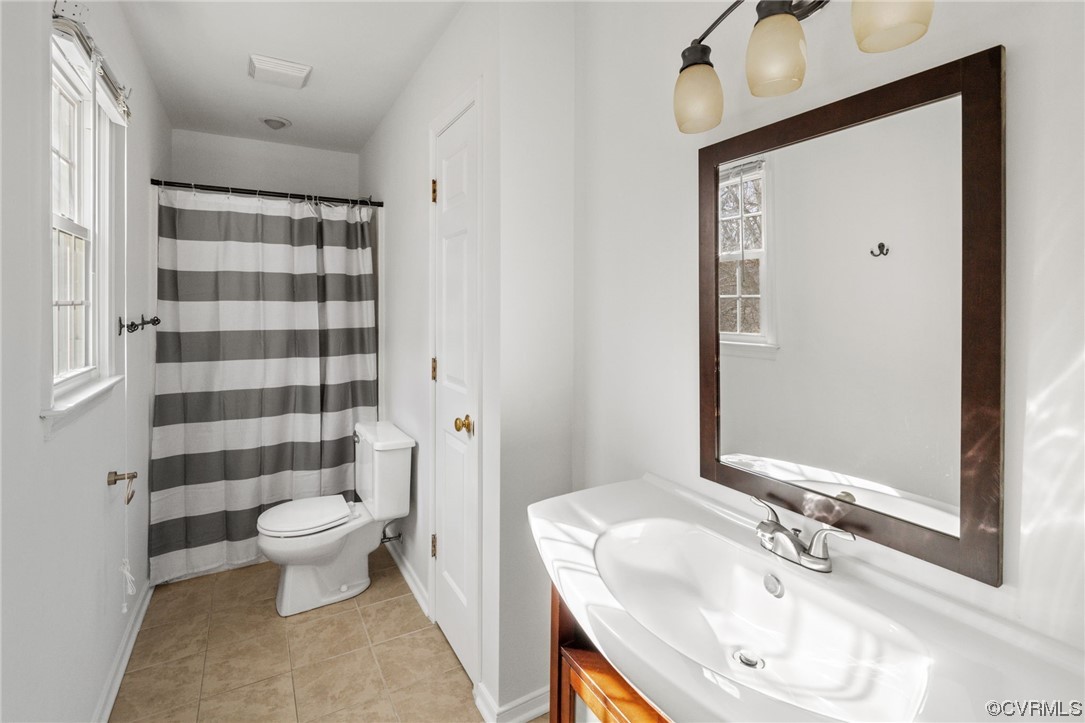13605 Danwoods Road Midlothian, VA 23113 - Photo 13 of 20 a bathroom with a sink toilet and shower