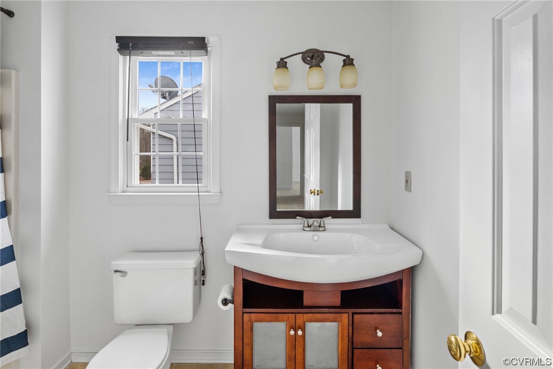 13605 Danwoods Road Midlothian, VA 23113 - Photo 16 of 20 a bathroom with a sink and a mirror