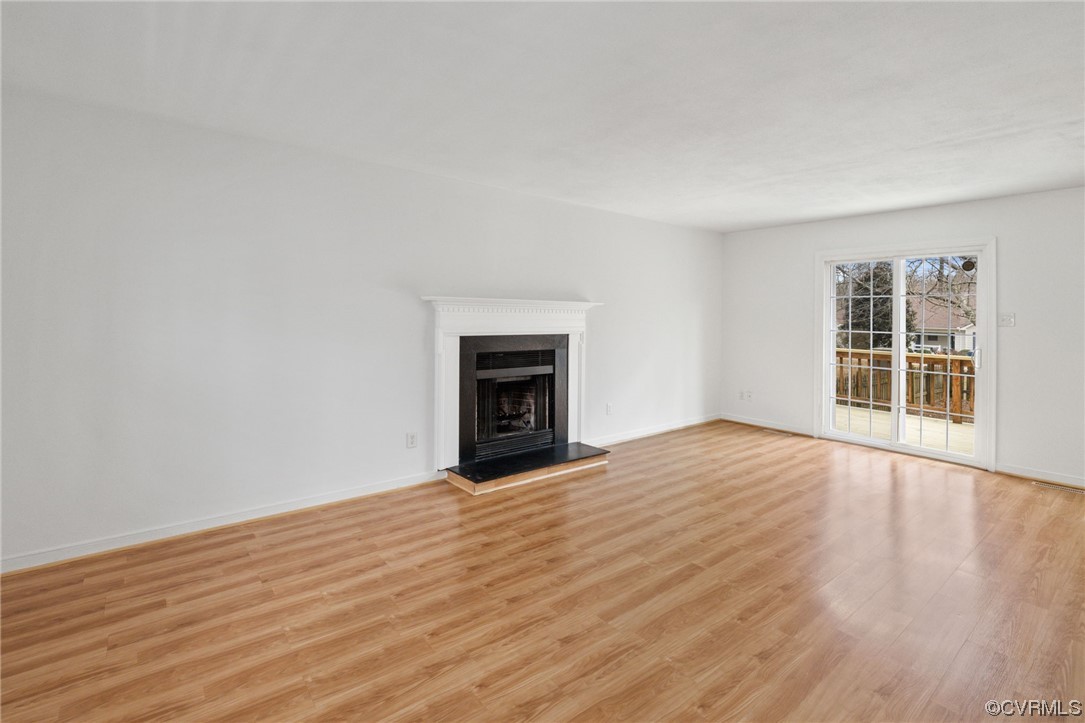 13605 Danwoods Road Midlothian, VA 23113 - Photo 2 of 20 a view of empty room with wooden floor and fireplace
