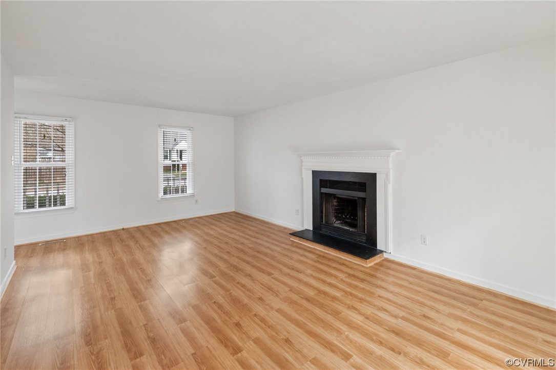 13605 Danwoods Road Midlothian, VA 23113 - Photo 4 of 20 an empty room with windows and fireplace