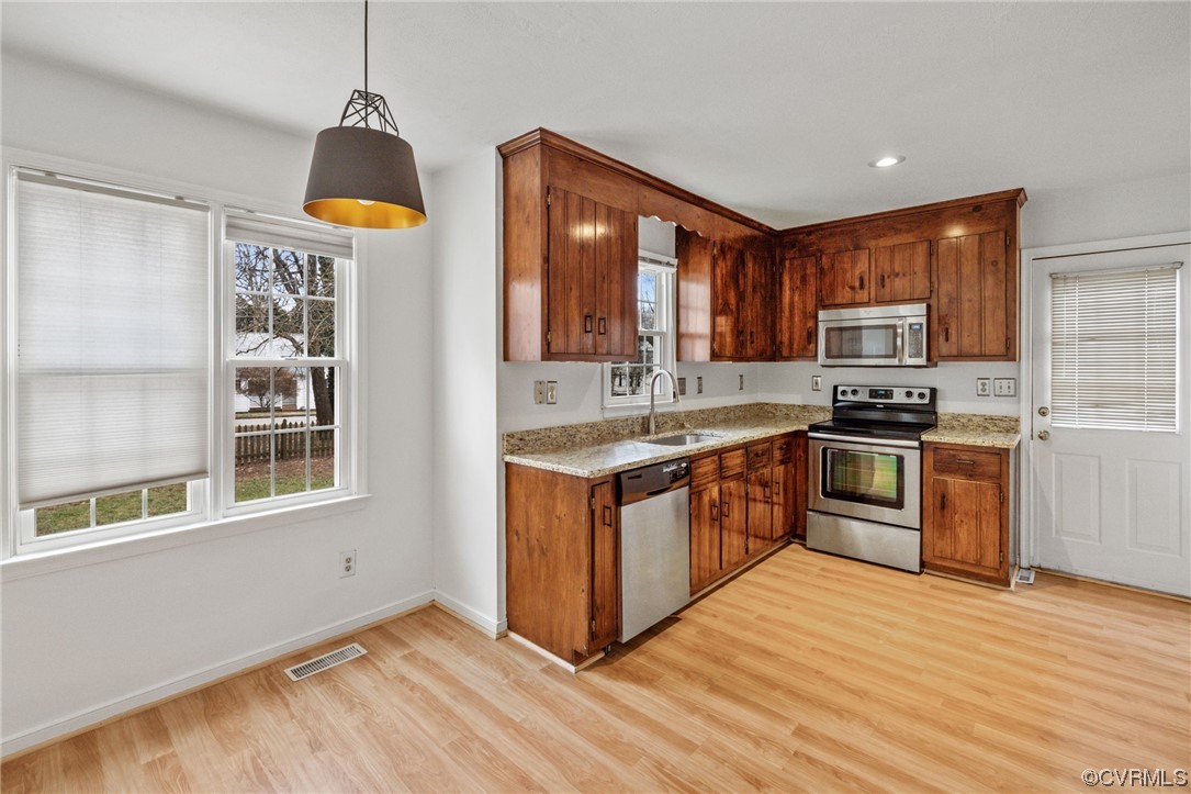 13605 Danwoods Road Midlothian, VA 23113 - Photo 6 of 20 a kitchen with stainless steel appliances granite countertop a stove a sink and a refrigerator