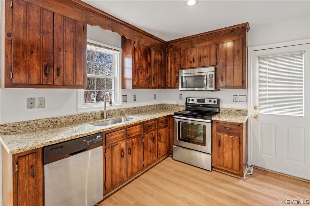 13605 Danwoods Road Midlothian, VA 23113 - Photo 7 of 20 a kitchen with stainless steel appliances granite countertop a stove a sink and a microwave
