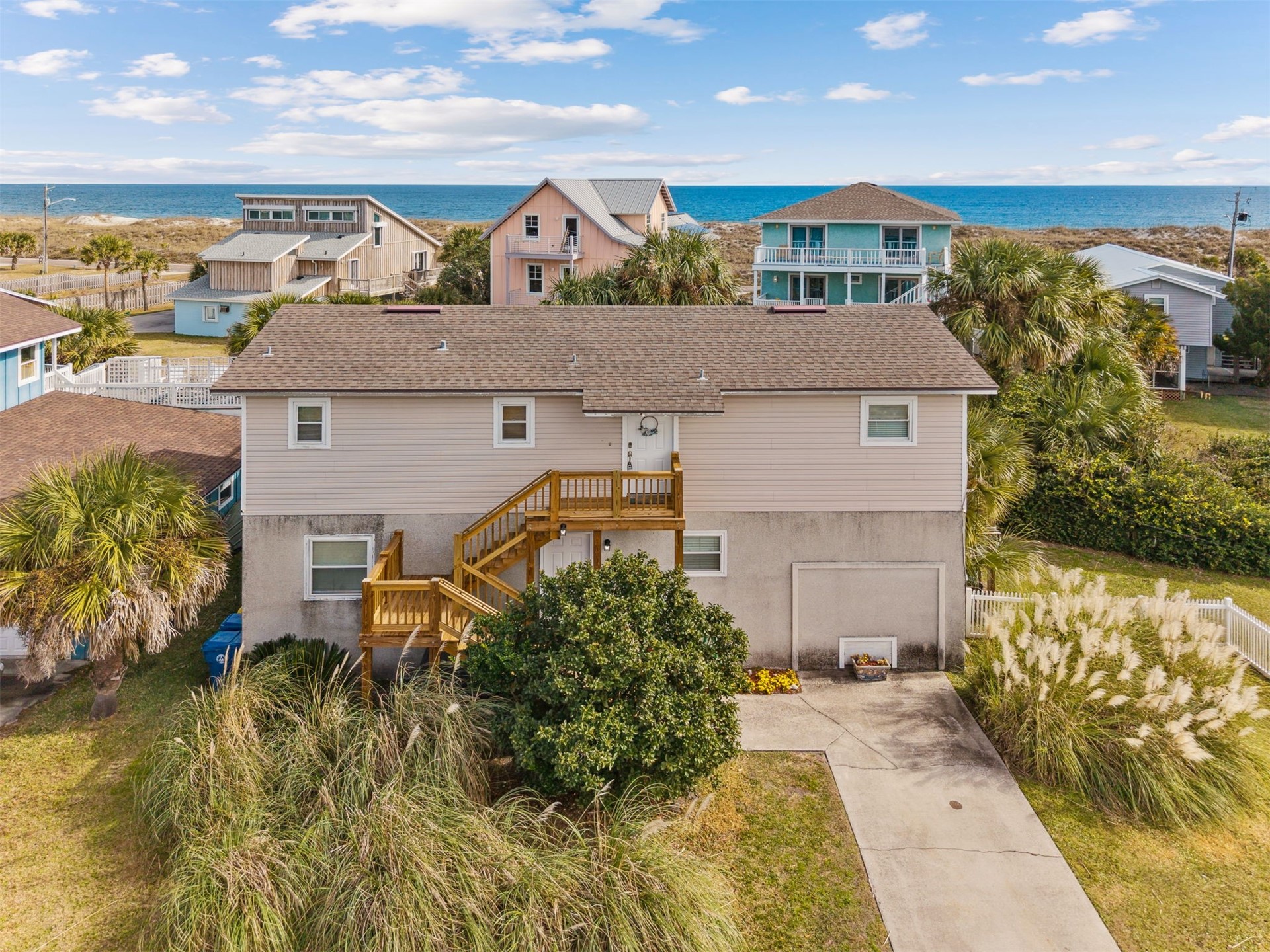 aerial view of a house with a yard and lake view