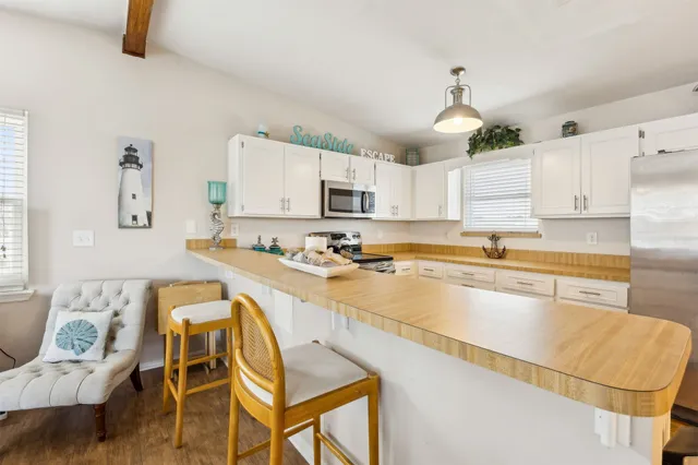 a kitchen with a sink stove and microwave