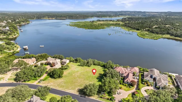 an aerial view of lake residential house with swimming pool and green space