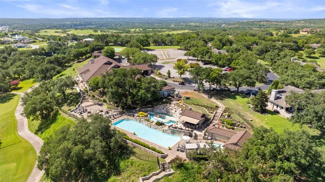 an aerial view of residential houses with outdoor space and lake view