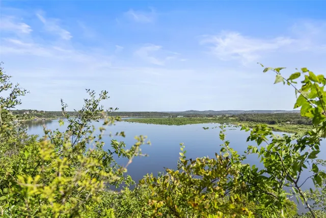 a view of a lake with houses in the back