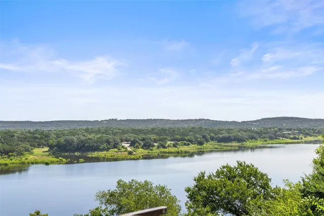 an aerial view of a houses with a lake view