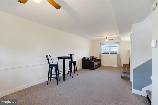 a view of a livingroom with furniture and a ceiling fan