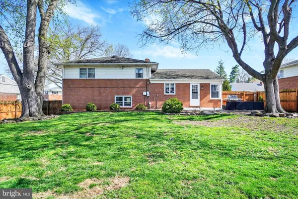 a backyard of a house with plants and tree