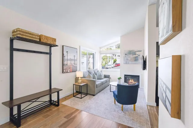a living room with furniture a fireplace and a table