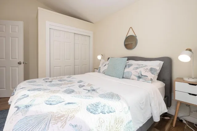 a bedroom with a bed and a lamp