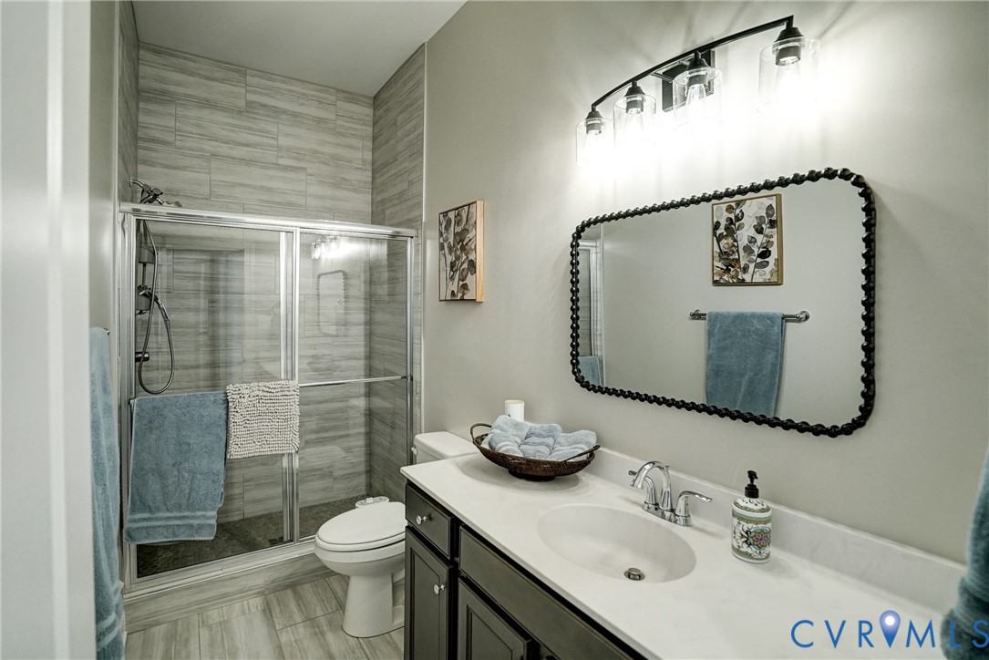4669 Woburn Road Providence Forge, VA 23140 - Photo 25 of 78 a bathroom with a sink a toilet and shower