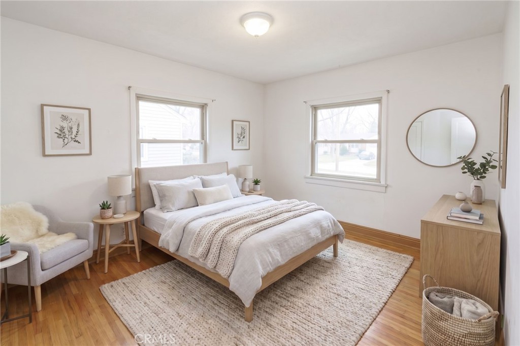 346 West School Street Compton, CA 90220 - Photo 19 of 29 a bedroom with a bed and wooden floor