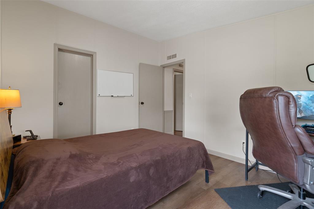 26255 Lambeth Road Brooksville, FL 34601 - Photo 33 of 76 a bedroom with a bed chair and mirror