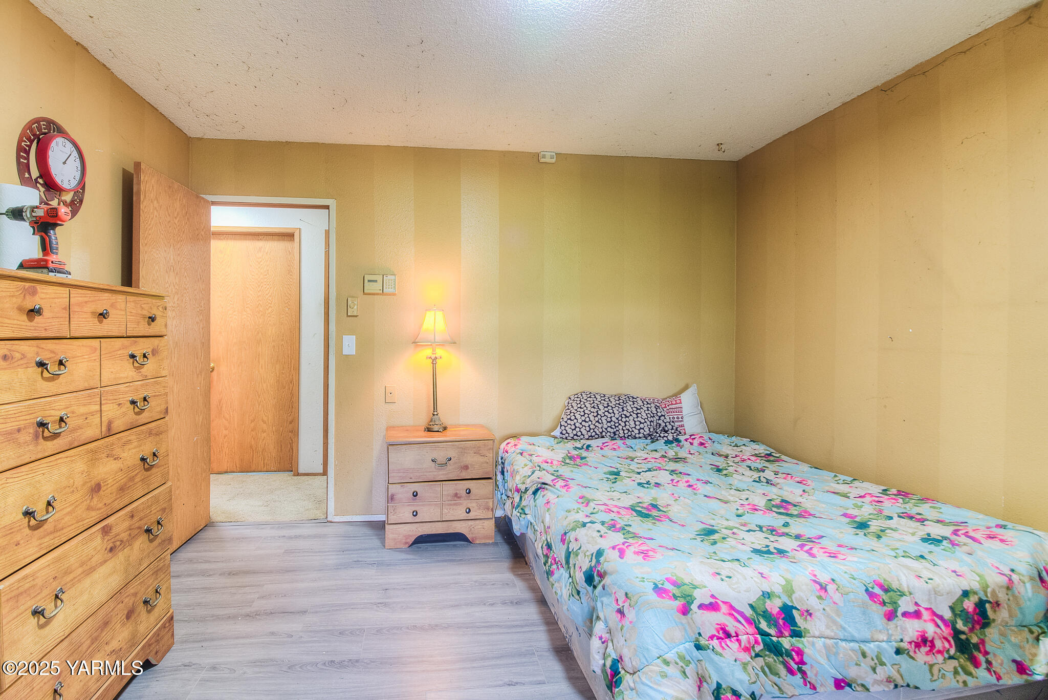 10608 Hackett Road Yakima, WA 98903 - Photo 17 of 40 a bedroom with a bed and wooden floor