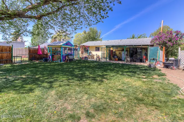a view of a house with a big yard and potted plants