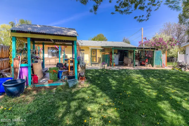 a view of a living room with furniture and a large tree