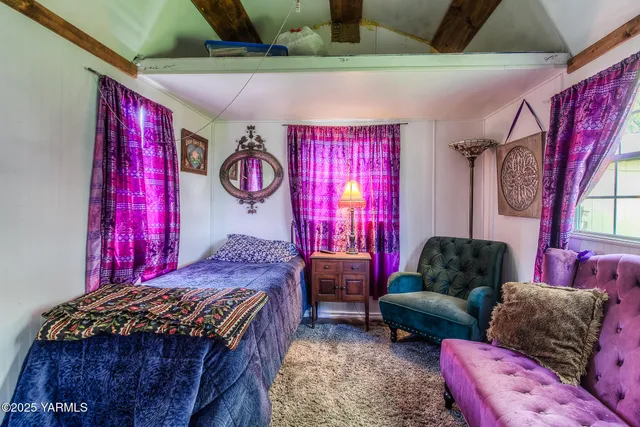 a bedroom with a bed and a couch