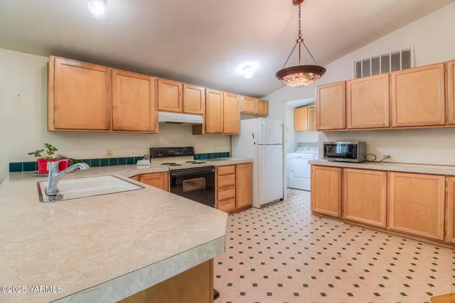 a kitchen with stainless steel appliances a refrigerator sink and cabinets