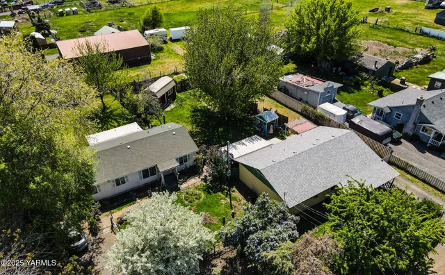 an aerial view of a house with a yard and lake view
