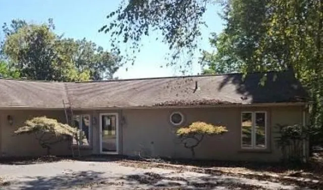 a front view of a house with a garden