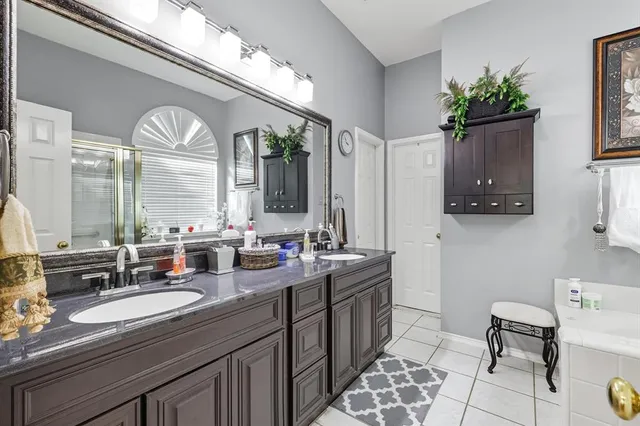a bathroom with a granite countertop sink mirror and vanity