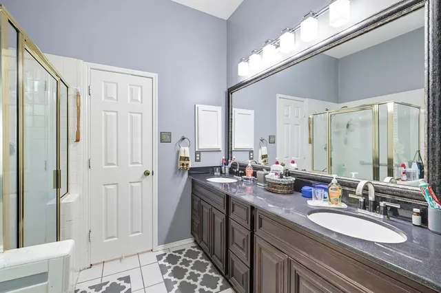 a bathroom with a double vanity sink and a mirror