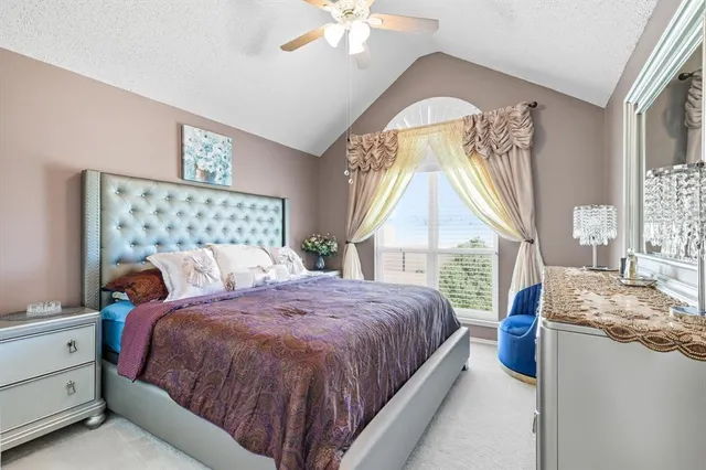 a bed sitting in a bedroom next to a window