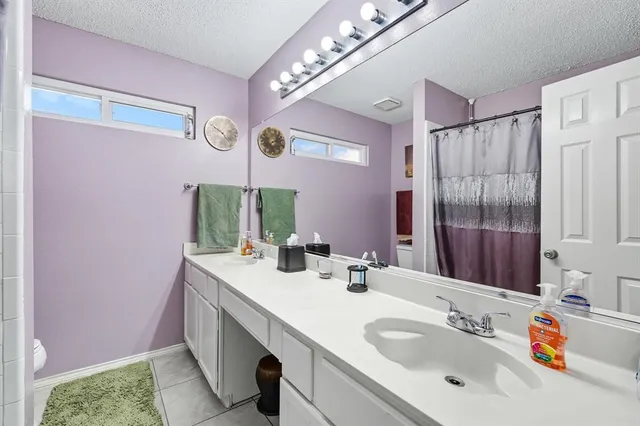a bathroom with a sink vanity tub and shower