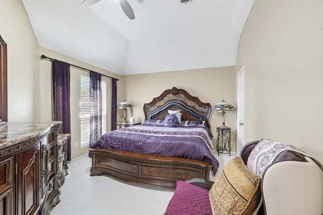 a spacious bedroom with a bed a couch and a window