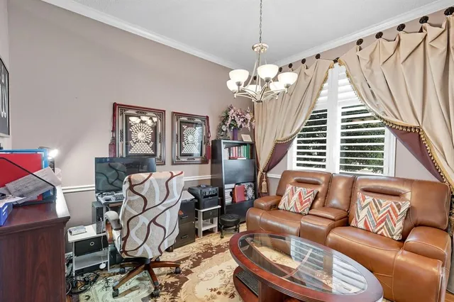 a living room with furniture and a chandelier