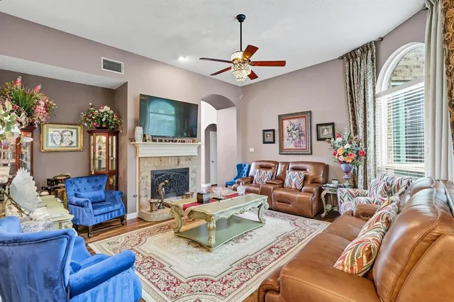 a living room with furniture a fireplace and a flat screen tv
