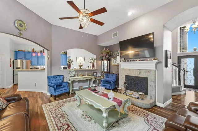 a living room with furniture a flat screen tv and a fireplace