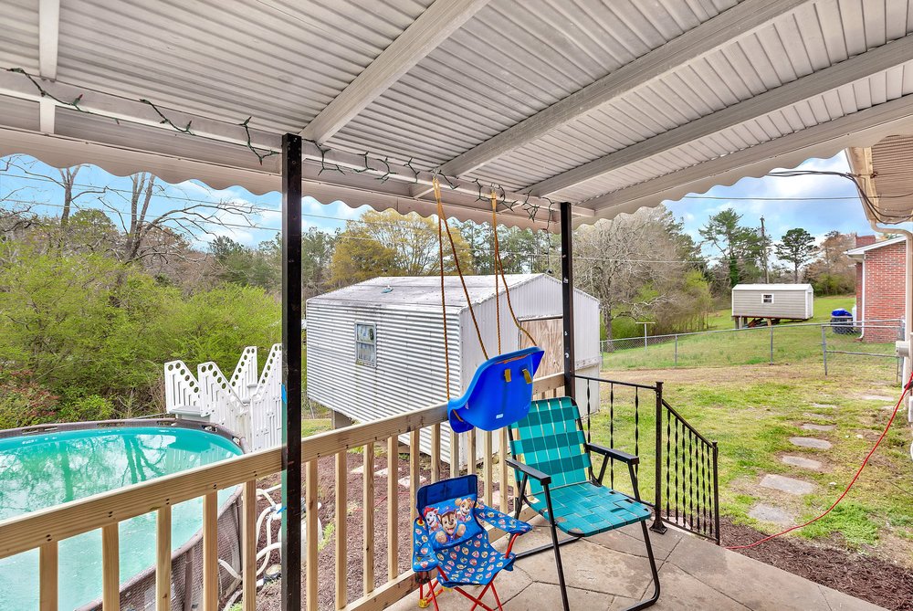920 White Cut Road Walhalla, SC 29691 - Photo 17 of 23 This backyard features a covered patio with an above-ground pool, offering both relaxation and recreation.