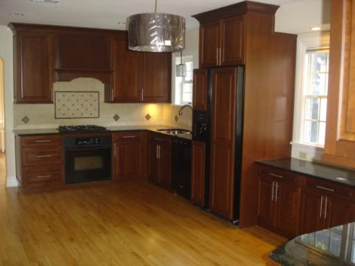 292 Blackhawk Road Riverside, IL 60546 - Photo 4 of 13 a kitchen with stainless steel appliances granite countertop a stove refrigerator and cabinets