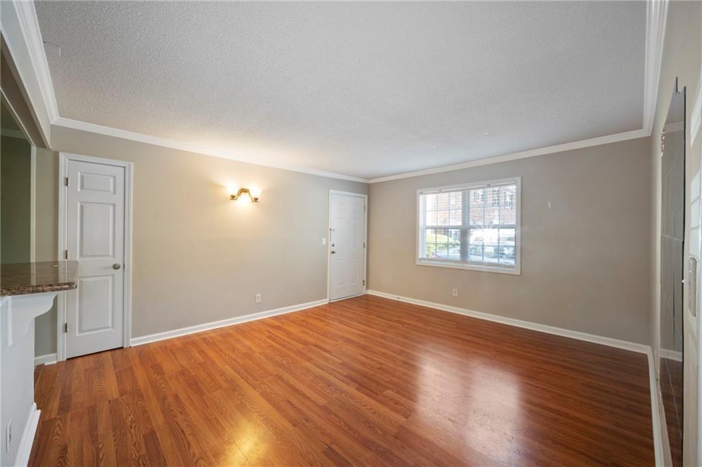 3665 Chestnut Drive, Unit D3 Atlanta, GA 30340 - Photo 16 of 16 a view of an empty room with wooden floor and a window
