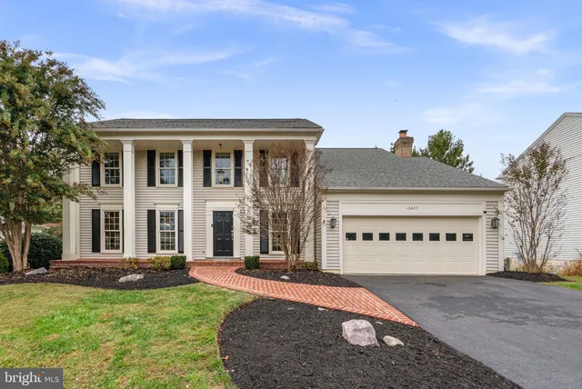 a front view of a building with a garden