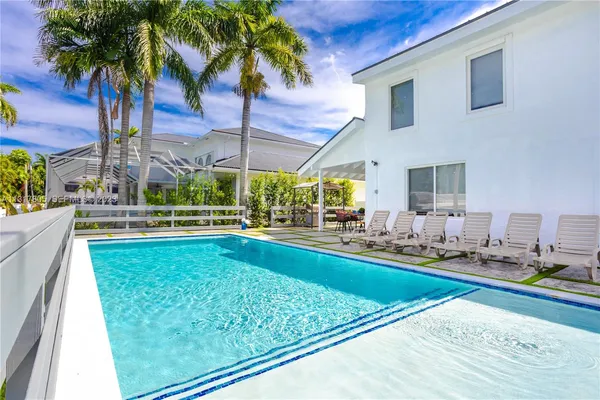 a swimming pool with outdoor seating and yard