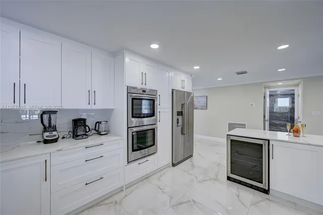 a dining room with furniture a chandelier and wooden floor