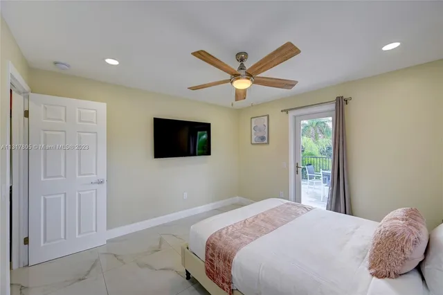 a bedroom with a large bed and a flat screen tv