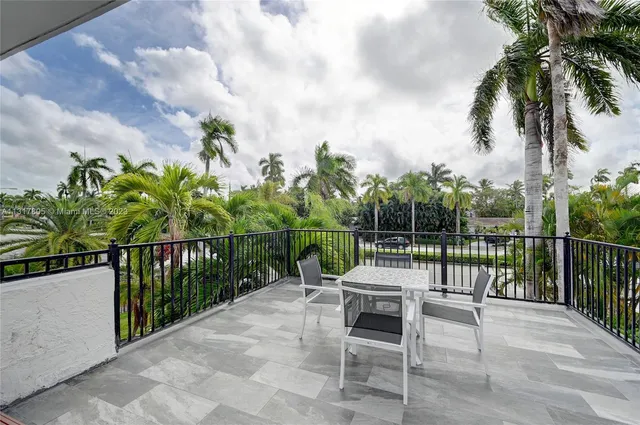 a spacious bedroom with a bed and a chandelier