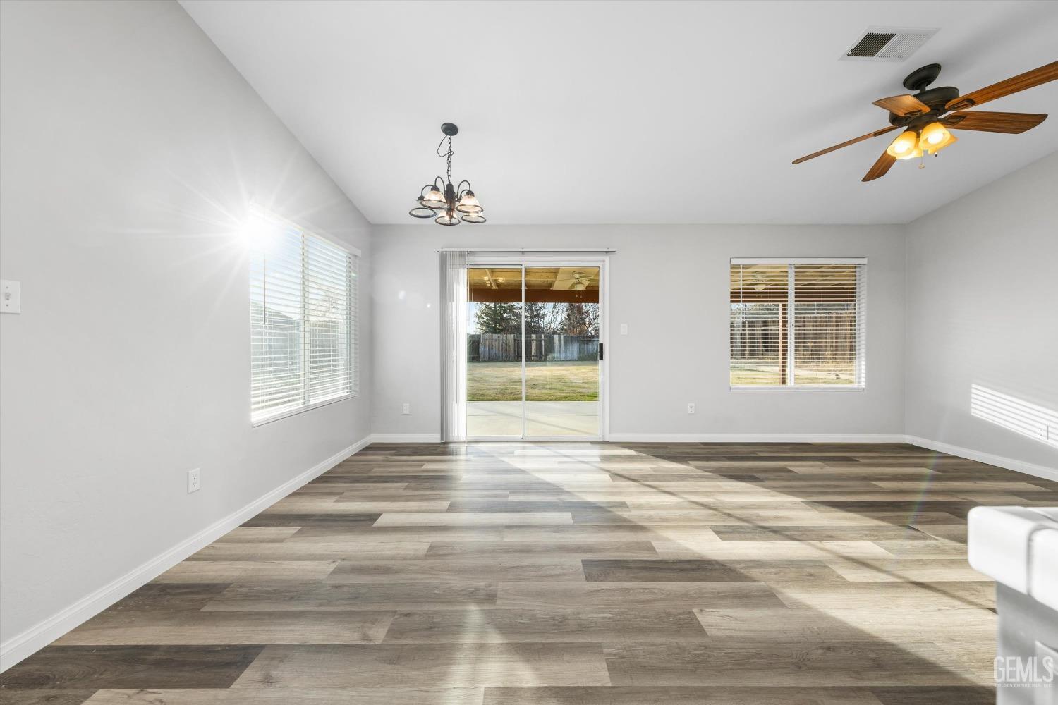 Undisclosed Address Bakersfield, CA 93308 - Photo 14 of 37 a view of an empty room with window and wooden floor