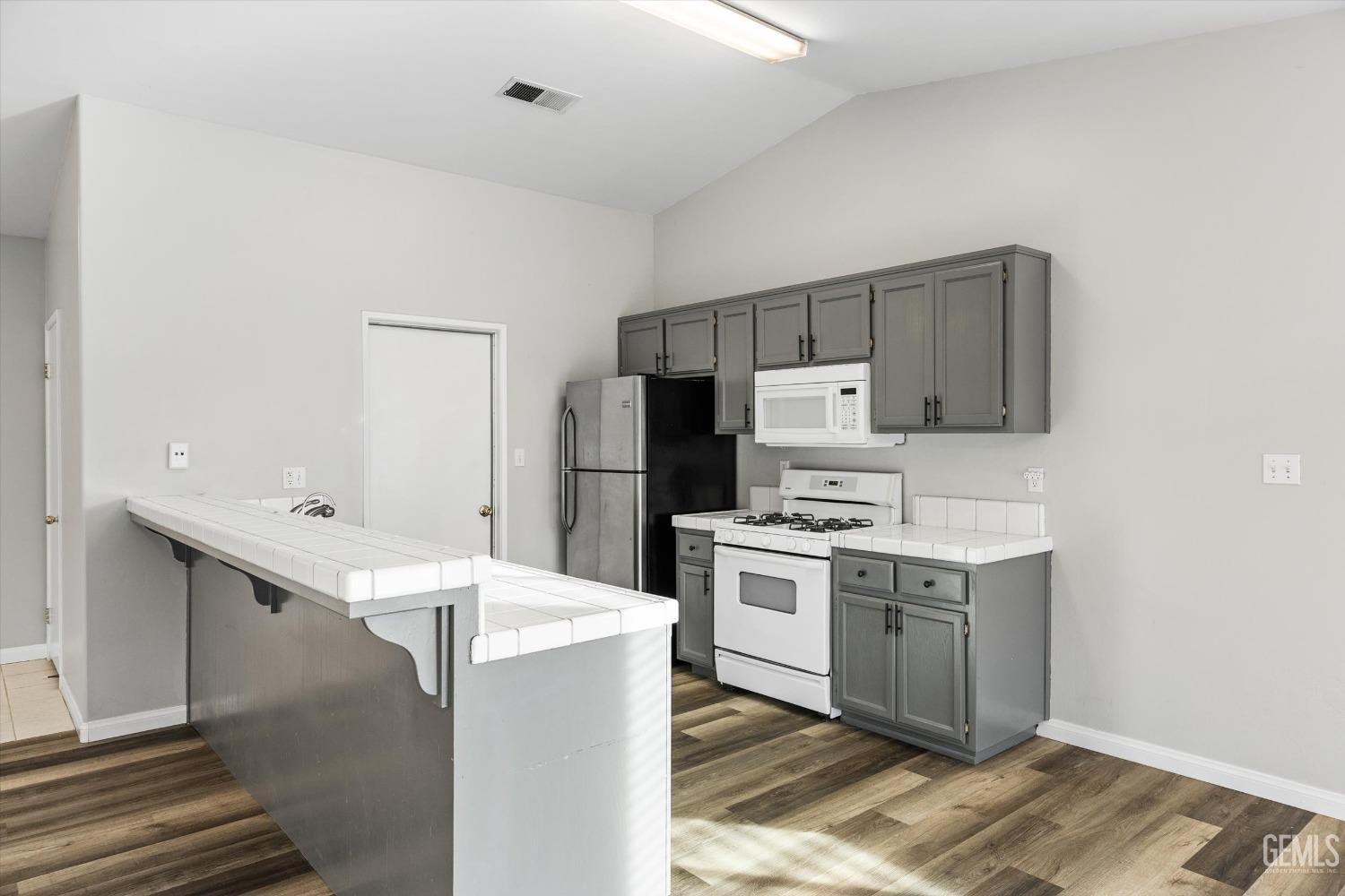 Undisclosed Address Bakersfield, CA 93308 - Photo 17 of 37 a kitchen with a sink a stove a refrigerator and a window