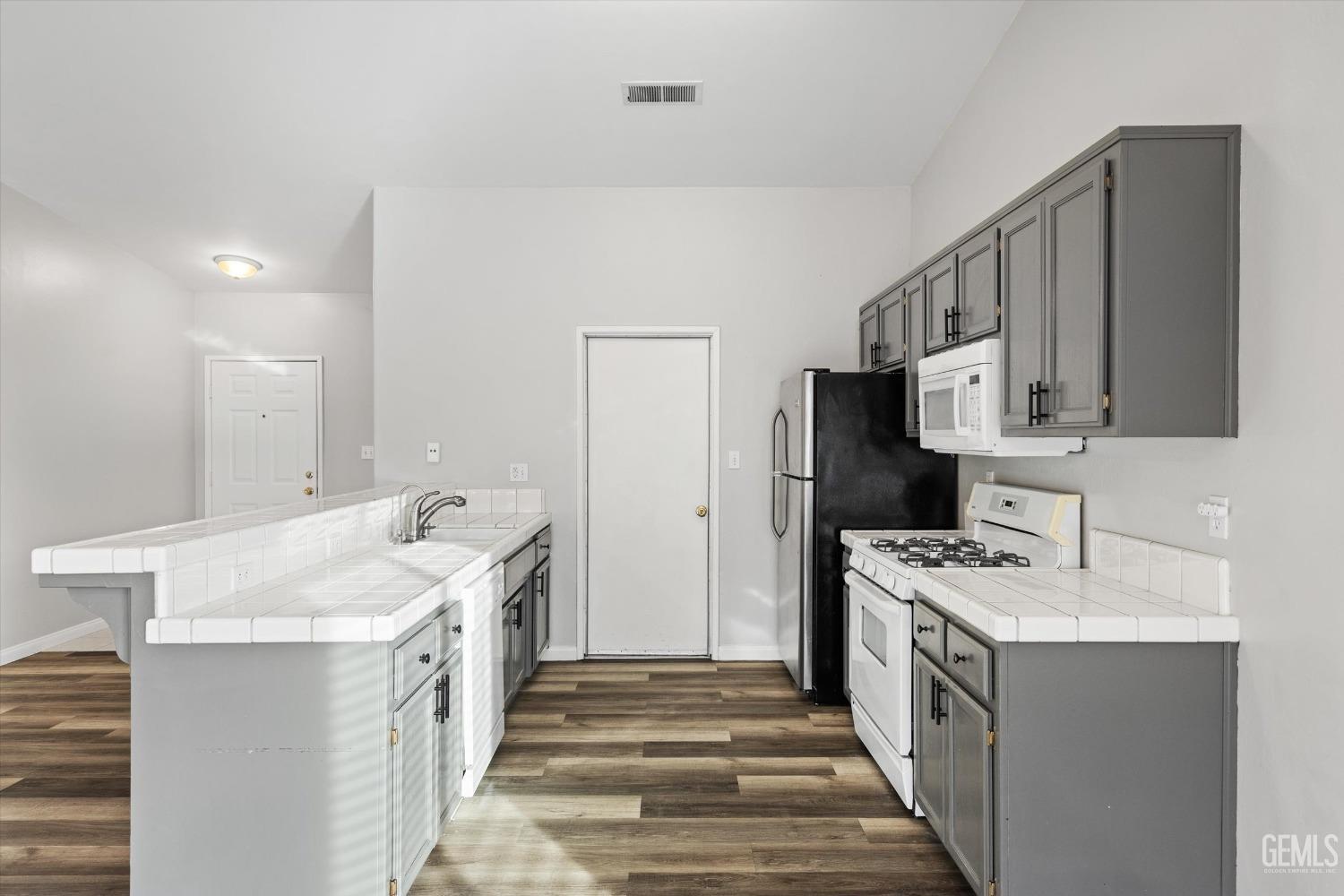 Undisclosed Address Bakersfield, CA 93308 - Photo 18 of 37 a kitchen with a sink stove and refrigerator