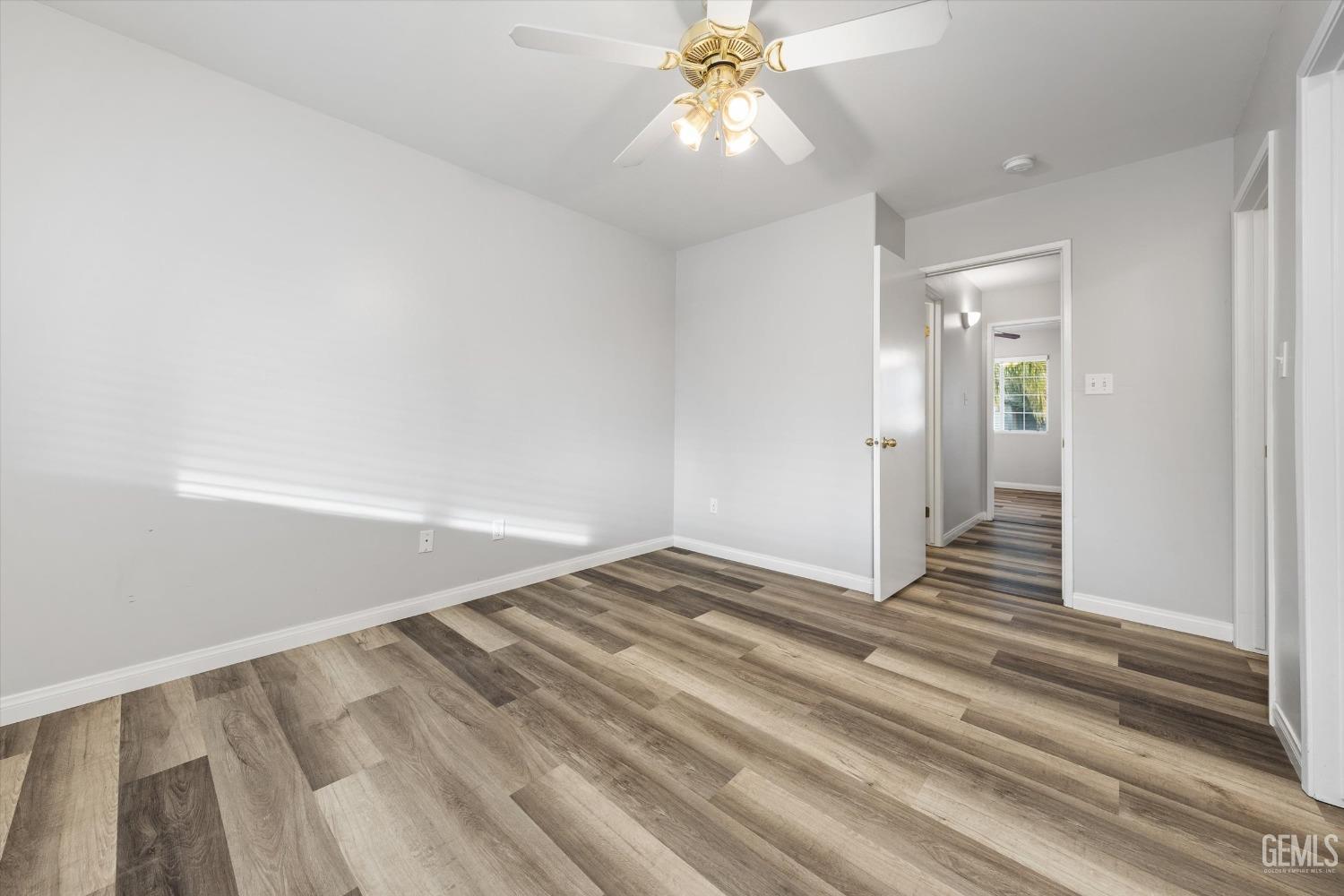 Undisclosed Address Bakersfield, CA 93308 - Photo 22 of 37 a view of a livingroom with wooden floor and a ceiling fan