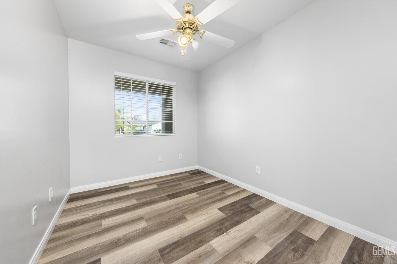 Undisclosed Address Bakersfield, CA 93308 - Photo 28 of 37 an empty room with a window and a fan