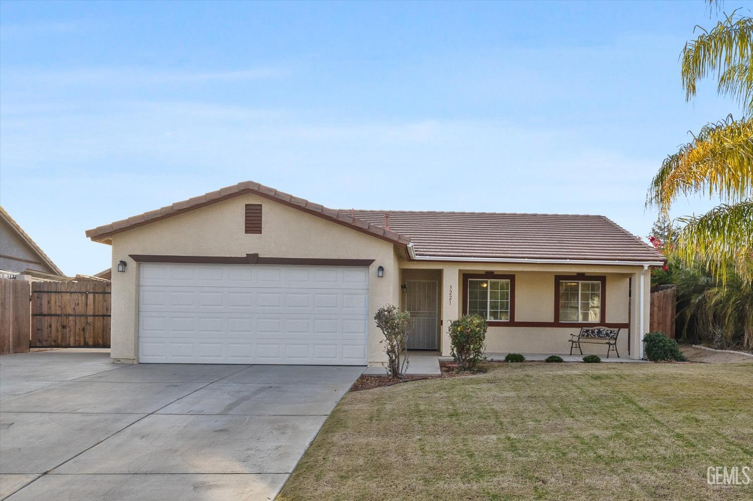 Undisclosed Address Bakersfield, CA 93308 - Photo 9 of 37 a view of a house with a yard and palm trees