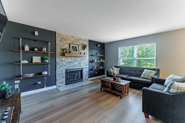 a living room with furniture and a fireplace